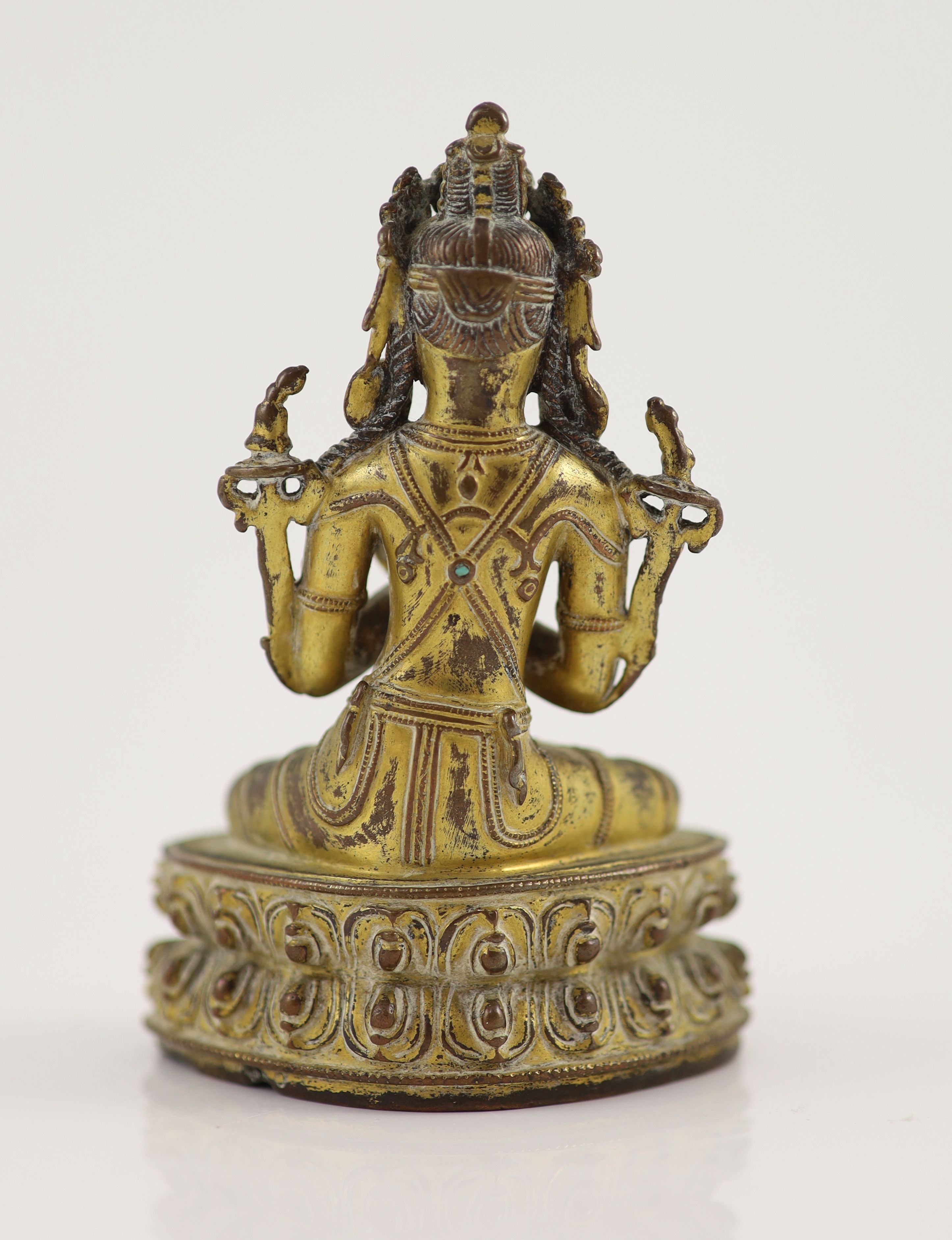 A Tibetan gilt copper alloy seated figure of Maitreya, possibly 15th century, 11.5 cm high